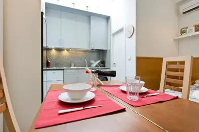 a dining room table with a red napkin on it at Host Wise - Cozy Quiet Flat - Trindade Station in Porto