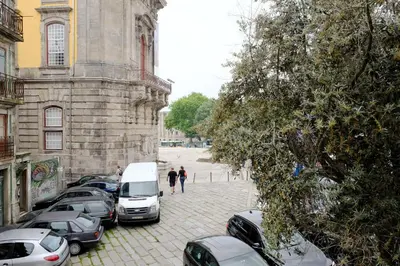 a group of cars parked in a parking lot next to a building at Koka's Studio in Porto