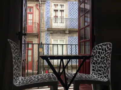 a table and two chairs in front of a window at Koka's Studio in Porto