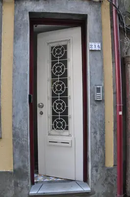 a white door with a window on a building at KOKAS Apartments in Porto
