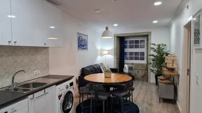 a kitchen with a small table and a sink at Merc Porto Ribeira's View in Porto