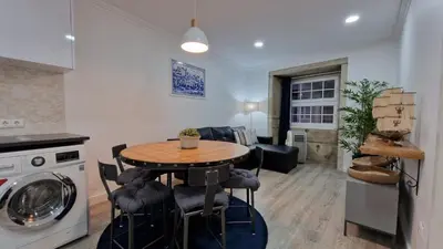 a kitchen and living room with a table and a washing machine at Merc Porto Ribeira's View in Porto