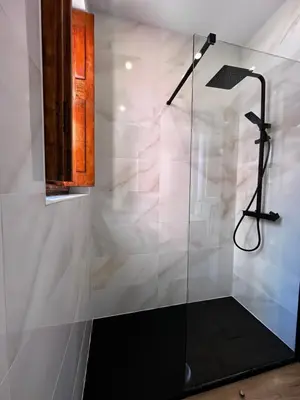 a bathroom with a glass shower and a bed at Best House Center - with Garage in Porto