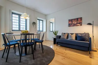 a living room with a table and chairs and a couch at Oporto Serviced Apartments - Alvares Cabral in Porto