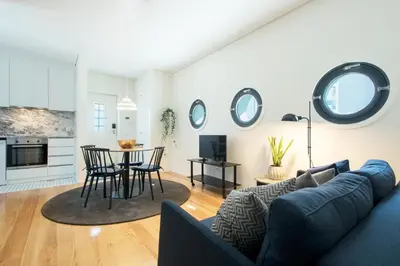 a living room with a couch and a table with chairs at Oporto Serviced Apartments - Alvares Cabral in Porto