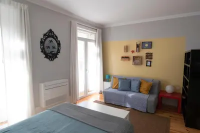 a living room with a bed and a couch at OPorto Histórico - Galerias in Porto