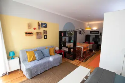 a living room with a couch and a dining room at OPorto Histórico - Galerias in Porto