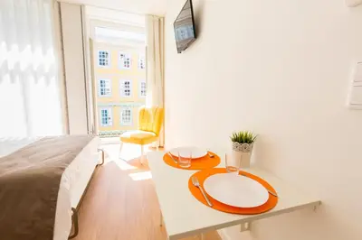 a bedroom with a table with two plates on it at Downtown Porto Mouzinho Studio Apts in Porto