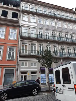 a black car parked in front of a building at Downtown Porto Mouzinho Studio Apts in Porto