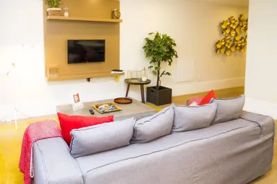 a living room with a gray couch with red pillows at Liiiving in Porto | Central Garden Flat in Porto