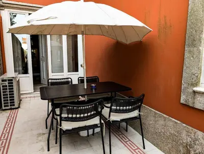 a living room with a gray couch with red pillows at Liiiving in Porto | Central Garden Flat in Porto
