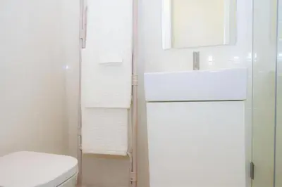 a bathroom with a toilet and a sink and a mirror at Liiiving in Porto | Central Garden Flat in Porto