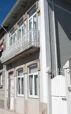 a white building with a balcony on top of it at Covelo Apartment in Porto