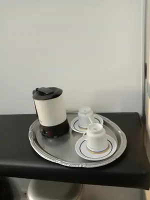 a coffee maker and two cups on a table at Faria Guimares Porto Centro in Porto