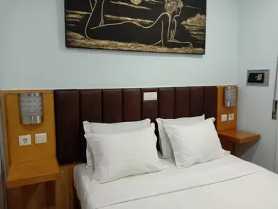 a bed with white pillows and a picture on the wall at Faria Guimares Porto Centro in Porto