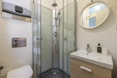 a bathroom with a shower and a toilet and a sink at D&S - Loureiro 67 in Porto