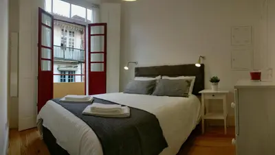 a bedroom with a large bed with towels on it at D&S - Loureiro 67 in Porto