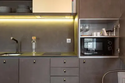 a kitchen with a sink and a microwave at Gold & Grey Loft Almada in Porto
