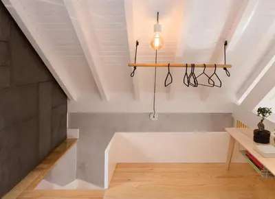 a staircase in a loft with a light fixture at Gold & Grey Loft Almada in Porto