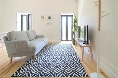 a living room with a couch and a television at Msc Flats in Porto