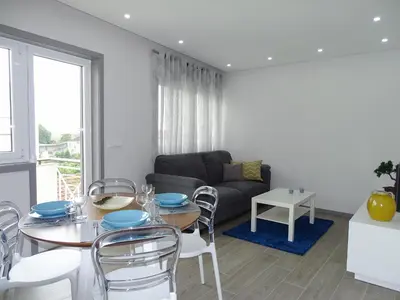a living room with a table and chairs and a couch at RS Porto Apartments in Porto