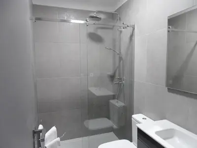a bathroom with a shower and a toilet and a sink at RS Porto Apartments in Porto