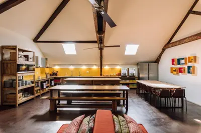 a kitchen with tables and chairs in a room at The Passenger Hostel in Porto