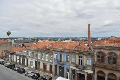 a group of buildings with cars parked on a street at Oporto Bernardes Studios - Heroísmo in Porto