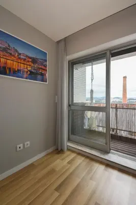 an empty living room with a large window with a view at Oporto Bernardes Studios - Heroísmo in Porto