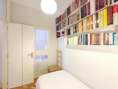 a painting hanging on a wall above a radiator at E36 - ideal for families - large areas in Porto