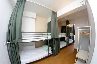 a room with three bunk beds in a room at Travel & Live Hostel in Porto