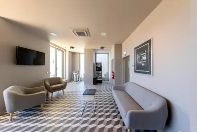 a living room with a couch and two chairs at Serviced Apartments Boavista Palace in Porto