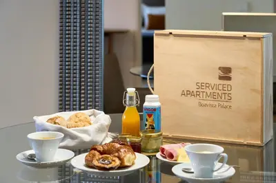 a table with two plates of pastries and a box at Serviced Apartments Boavista Palace in Porto
