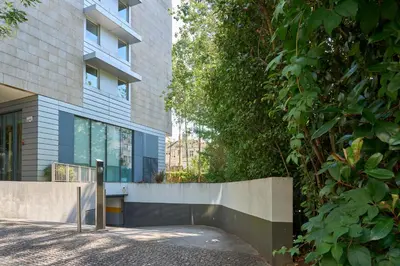 an external view of a building with a fence at Serviced Apartments Boavista Palace in Porto