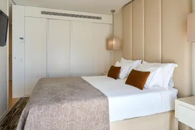 a bedroom with a large white bed with white pillows at Serviced Apartments Boavista Palace in Porto