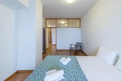 a bedroom with a bed with two towels on it at BEST - Trindade Tower in Porto