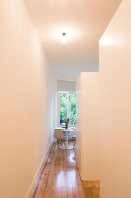 an empty room with a table and a window at Zelije Apartments Trindade in Porto