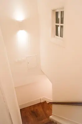 a stairwell with a light and a window at Zelije Apartments Trindade in Porto