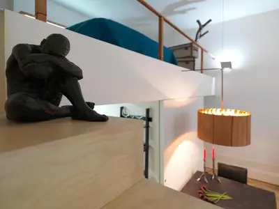 a statue of a person sitting on top of a table at FLH Porto Stylish Apartment in Porto