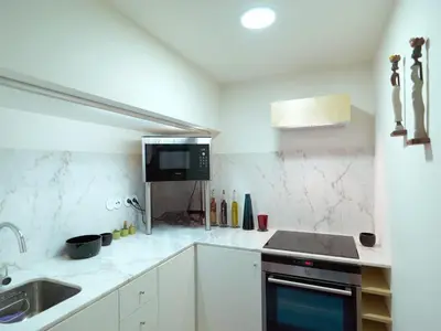 a white kitchen with a sink and a stove at FLH Porto Stylish Apartment in Porto