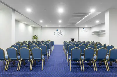 a conference room with tables and chairs and a screen at Hotel Cristal Porto in Porto