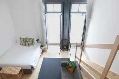 a living room with a bed and a couch at Citybreak-apartments Coliseu in Porto