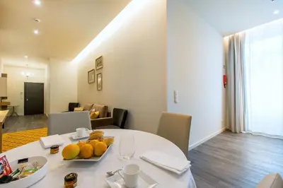 a dining room with a white table with fruit on it at LETHESHOME Apartments in Porto