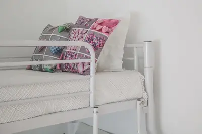 a white bunk bed with a pillow on it at Apartamento À Francos Balcony in Porto