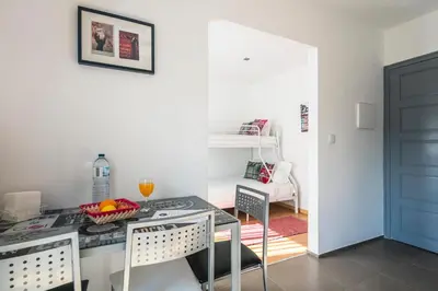 a kitchen with a table and chairs in a room at Apartamento À Francos Balcony in Porto