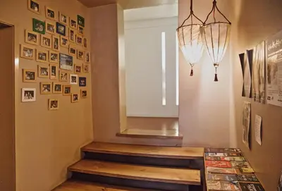 a hallway with a staircase with pictures on the wall at Porto Spot Hostel in Porto
