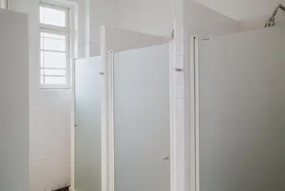 a bathroom with two white refrigerators and a window at Porto Spot Hostel in Porto