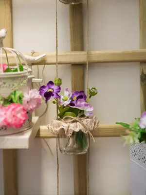 a hanging flower pot with flowers in it on a shelf at OPORTO GUEST Cedofeita Terrace in Porto