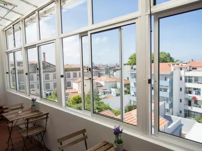 a room with windows and a view of the city at OPORTO GUEST Cedofeita Terrace in Porto
