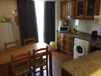a kitchen with a table and a washing machine at Downtown PORTO SE in Porto